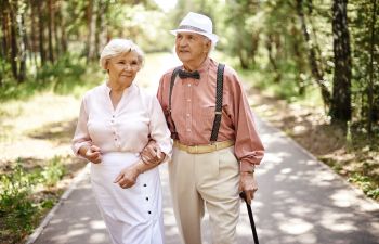 Elderly Couple Walking on a Path in the Woods