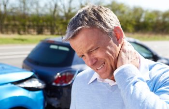 man with pain neck after car collision