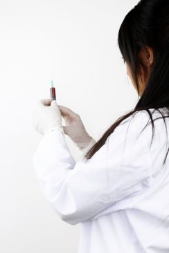 doctor with syringe preparing injection