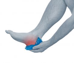 person puting a compress on a painful heel