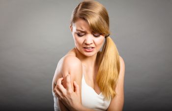 Woman Grabbing Her Arm in Pain