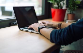 Man Typing on a Laptop