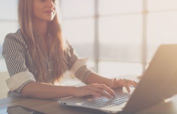 woman typing on laptop